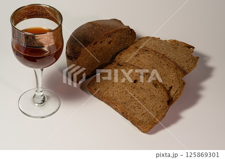 Wine and bread on a white background Wine and bread on a white background 125869301