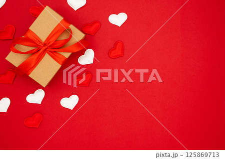 Valentine's Day background. Red and white hearts and box for St. Valentine's day gift. Concept of Valentine's, anniversary, mother's day and birthday greeting, copy space, top view Valentine's Day background. Red and white hearts and box for St. Valentine's day gift. Concept of Valentine's, anniversary, mother's day and birthday greeting, copy space, top view 125869713
