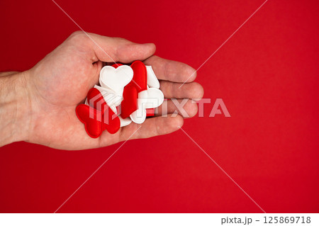 Many decorative hearts in the palm. Valentine's Day, love, health theme 125869718