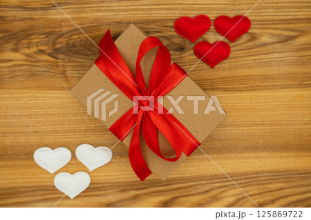 Gift box and hearts on wood background. Valentine's day Gift box and hearts on wood background. Valentine's day 125869722