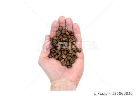 Coffee beans in the hand, isolated on a white background Coffee beans in the hand, isolated on a white background 125869830