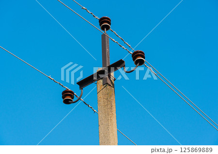The close up of electricity power cable on concrete pole. Electric power industry The close up of electricity power cable on concrete pole. Electric power industry 125869889