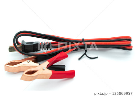 Cable with Crocodile clip. Metal crocodile clip. Black and red wires with copper clamps isolated on a white background Cable with Crocodile clip. Metal crocodile clip. Black and red wires with copper clamps isolated on a white background 125869957
