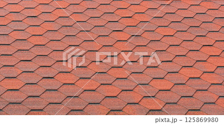 View of red bituminous roof tiles. Asphalt shingles roofing construction. Template for roofers View of red bituminous roof tiles. Asphalt shingles roofing construction. Template for roofers 125869980