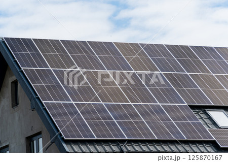 New solar panels installed on metal sheet roof of the house 125870167