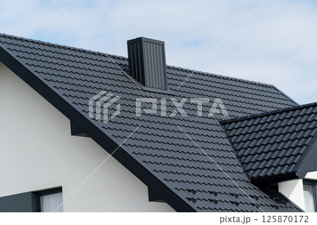 The house is covered with a modern metal roof 125870172