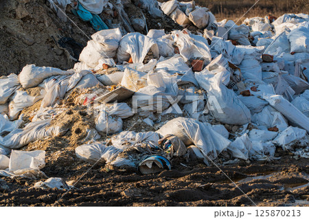 Huge landfill of garbage. Garbage or waste dumped. Garbage in the bags Huge landfill of garbage. Garbage or waste dumped. Garbage in the bags 125870213