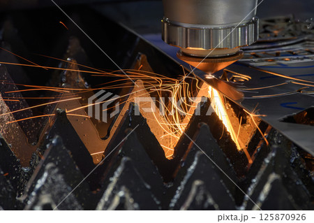 The fiber laser cutting machine cut the metal plate with the sparkling light. The fiber laser cutting machine cut the metal plate with the sparkling light. 125870926