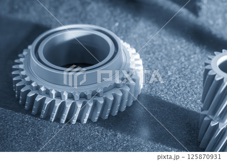 Close up scene small gear shape part from the metal 3D printing method in the light blue scene. 125870931