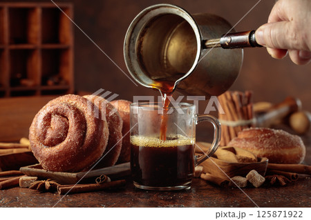 Swedish cinnamon rolls and black coffee. 125871922