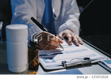 Male and female doctors are having a meeting in a hospital room. 125872026