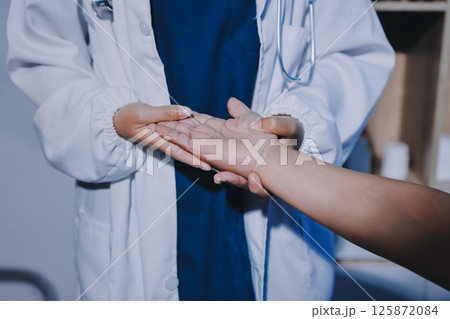 Orthopedist examining patient in hospital 125872084