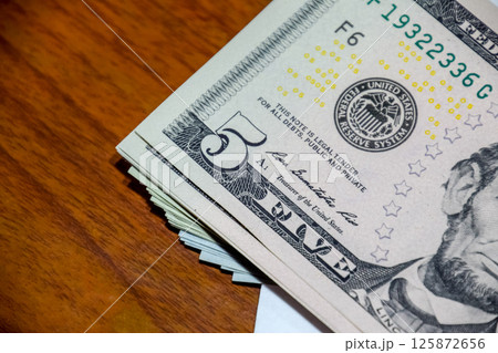 Dollars on a wooden table. Money on table. American dollars. 125872656