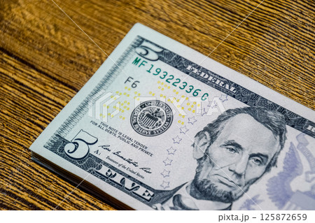 Dollars on a wooden table. Money on table. American dollars. 125872659