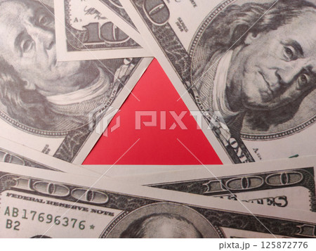 The red triangle is in the middle of the hundred dollars. 125872776