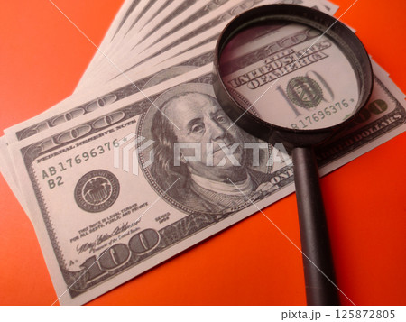 Closeup magnifying glass on a one hundred dollars. Closeup magnifying glass on a one hundred dollars. 125872805