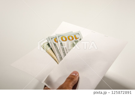Dollars in a conwind on white background, a lot of money in an envelope. 125872891