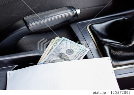 wad of dollars inside the car. wad of dollars inside the car. 125872892