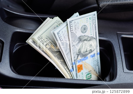 wad of dollars inside the car. wad of dollars inside the car. 125872899