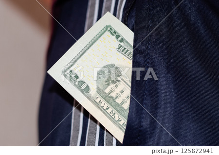 wad of money in the pocket of a man's pants. Dollars in your pocket. 125872941