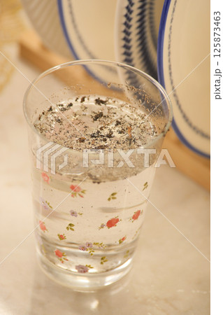 dirty glass of water on kitchen table dirty glass of water on kitchen table 125873463