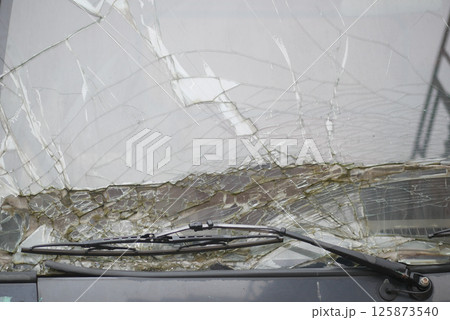 Windshield damage on a bus during a stormy weather event 125873540