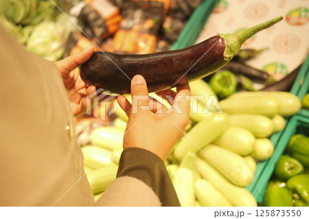 Choosing fresh vegetables at a local market in the afternoon 125873550