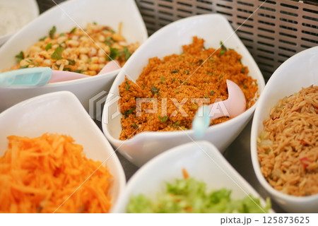 Colorful array of salads and side dishes at a buffet table Colorful array of salads and side dishes at a buffet table 125873625