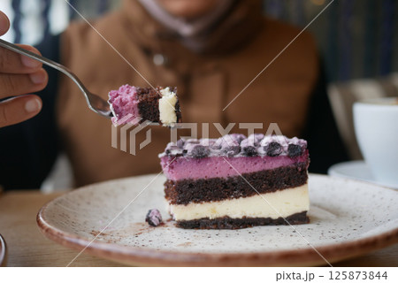 Enjoying a colorful dessert at a cozy cafe in the afternoon Enjoying a colorful dessert at a cozy cafe in the afternoon 125873844