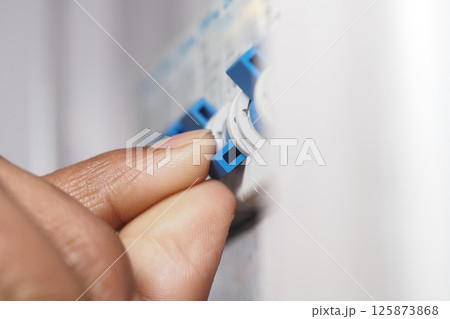 Adjusting the settings on an electrical control panel during repairs 125873868