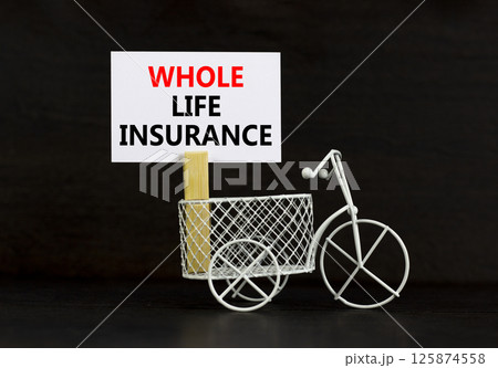Whole life insurance symbol. Concept words Whole life insurance on beautiful white paper on clothespin. Beautiful black background. Miniature bicycle. Business whole life insurance concept Copy space 125874558
