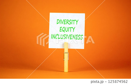 DEI diversity equity inclusiveness symbol. Concept words Diversity Equity Inclusiveness on white paper. Beautiful orange background. Business DEI diversity equity inclusiveness concept. Copy space. 125874562