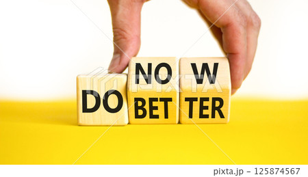 Do better and now symbol. Concept words Do better Do now on wooden block. Beautiful yellow table white background. Businessman hand. Business do better and now concept. Copy space. Do better and now symbol. Concept words Do better Do now on wooden block. Beautiful yellow table white background. Businessman hand. Business do better and now concept. Copy space. 125874567