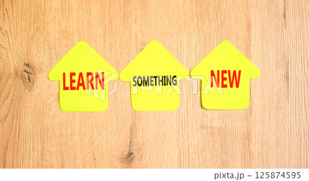 Learn something new symbol. Concept words Learn something new on beautiful yellow paper houses. Beautiful wooden background. Business motivational lifestyle learn something new concept. Copy space. 125874595