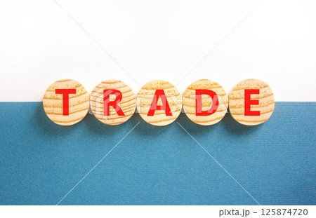 Trade symbol. Concept word Trade on beautiful wooden circles. Beautiful white and blue background. Business lifestyle trade concept. Copy space. 125874720