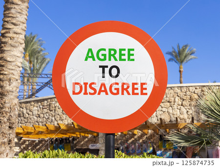 Agree to disagree symbol. Concept words Agree to disagree on beautiful big white road sign. Beautiful palm tree hotel blue sky background. Business and agree to disagree concept. Copy space. 125874735