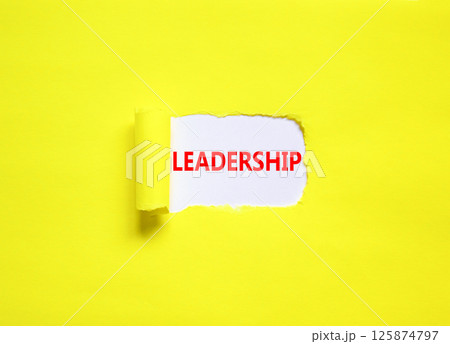 Leadership symbol. Concept word Leadership on beautiful white paper. Beautiful yellow paper background. Business leadership concept. Copy space. Leadership symbol. Concept word Leadership on beautiful white paper. Beautiful yellow paper background. Business leadership concept. Copy space. 125874797