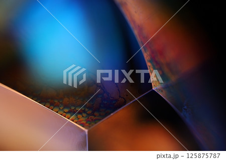 Bright rainbow reflection of liquid, blue and green colours, surrealistic pattern 125875787