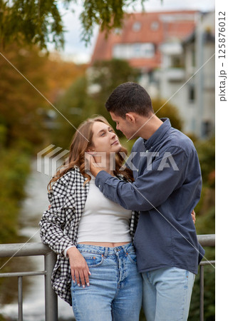 Young Cute Female Hugs Boyfriend. In Autumn Outdoor. Lovers Walking in Park. Attractive Funny Couple. Lovestory in Forest. Man and Woman. Cute Lovers in the Park. Family Concept. Happy Couple. 125876012