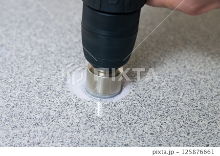 rotating diamond core hole cutter in hand power drill drills stone slab 125876661