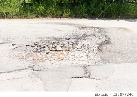 Asphalt road surface crack or damage. 125877240