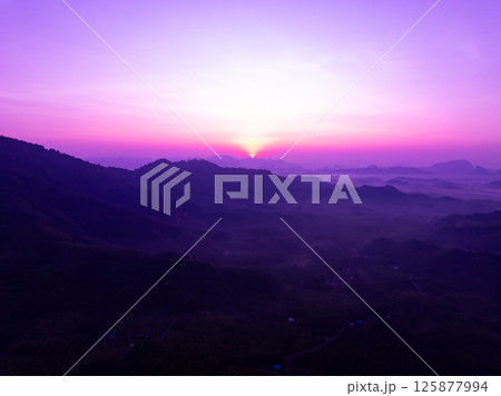 Aerial view landscape mountains colorful purple sky over sea Aerial view landscape mountains colorful purple sky over sea 125877994