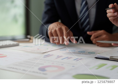 Business Collaboration and Analytics Discussion. Professionals analyzing sales data and statistics during a strategic meeting. Business Collaboration and Analytics Discussion. Professionals analyzing sales data and statistics during a strategic meeting. 125879807