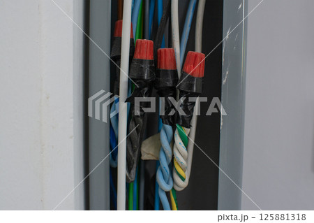 group of power lines inside electrical wireway installed on the wall 125881318