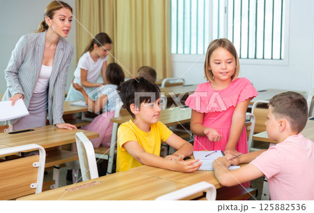 Tweens working in small groups during lesson at school 125882536