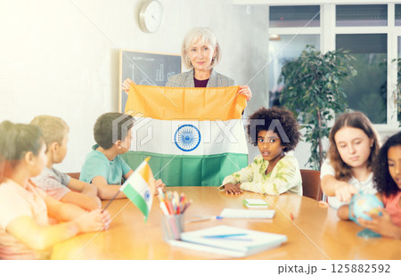 students listen to woman teacher who talks about India students listen to woman teacher who talks about India 125882592