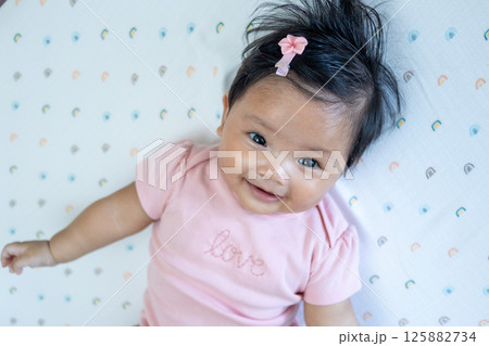 Joyful newborn baby smiling asian infant in cozy room child bright atmosphere heartwarming concept Joyful newborn baby smiling asian infant in cozy room child bright atmosphere heartwarming concept 125882734