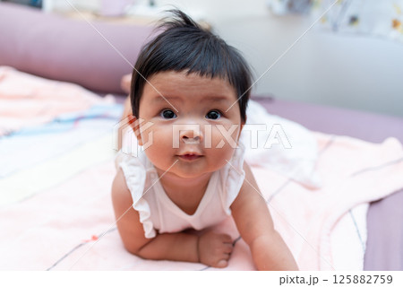Adorable asian newborn baby in cozy home setting captivating portrait soft colors gentle vibes 125882759