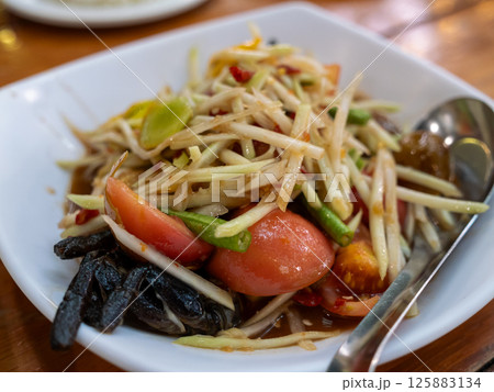 Delicious thai green papaya salad recipe thailand food authentic close-up cuisine Delicious thai green papaya salad recipe thailand food authentic close-up cuisine 125883134