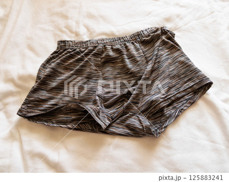 Casual fashion choices boxer shorts bed clothing indoor close-up comfort concept 125883241